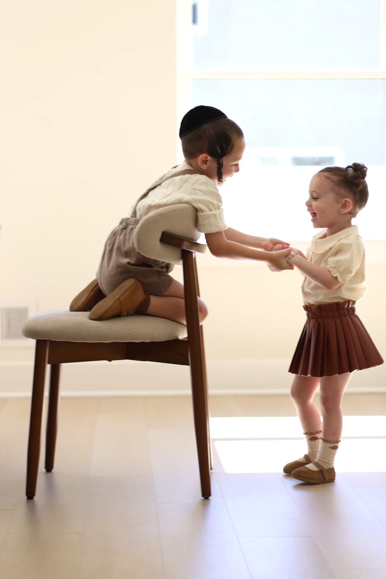 Brother and sister working out the chair together.