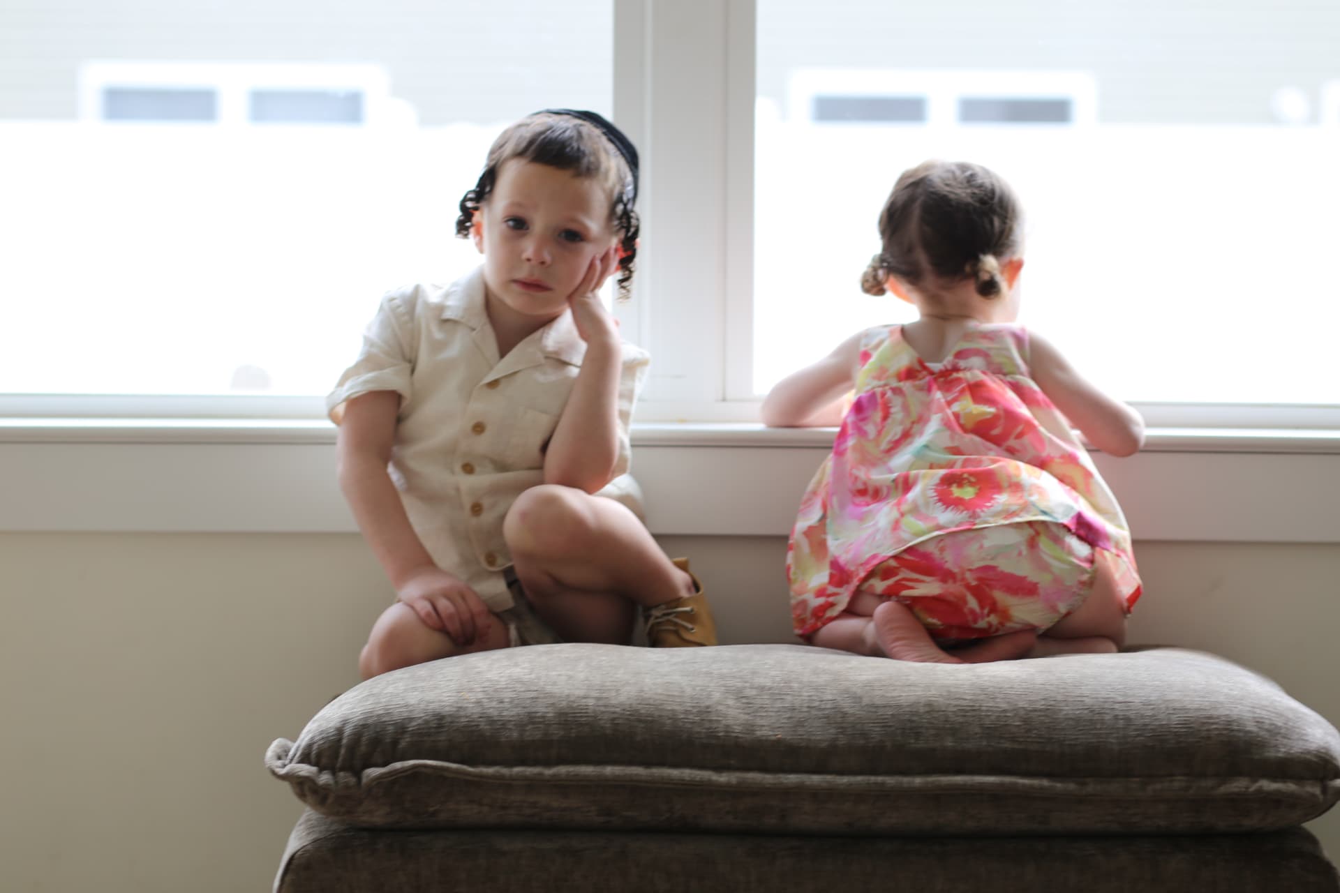 Brother and sister on the window seat.