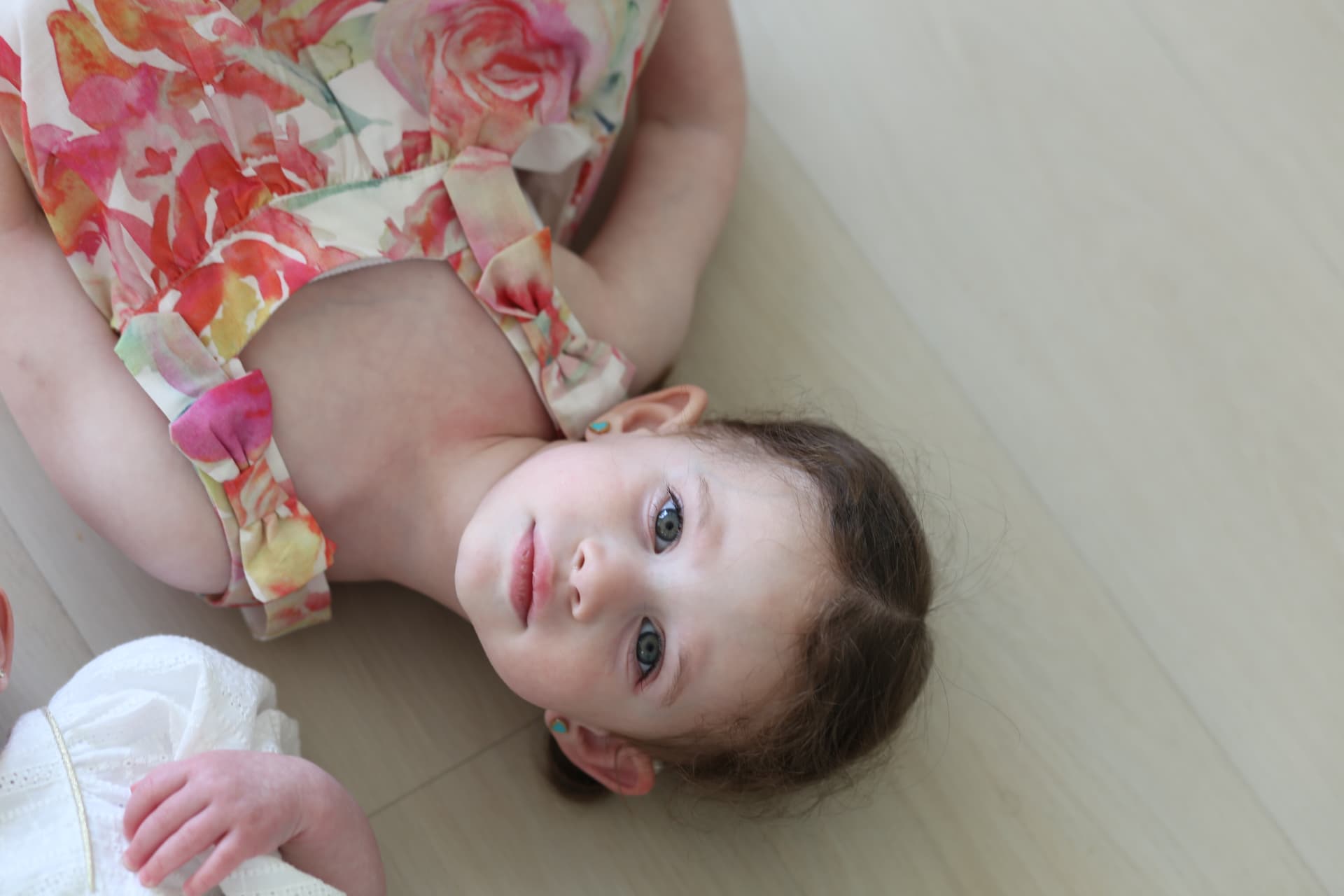 Lying on the floor, looking straight up.