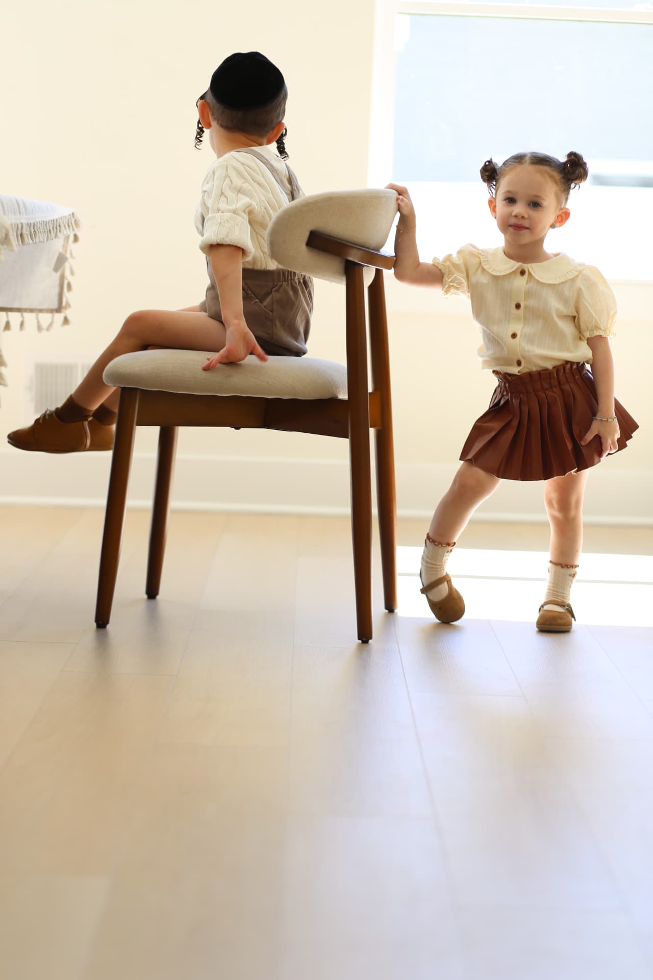 She dances while he waits on the chair.