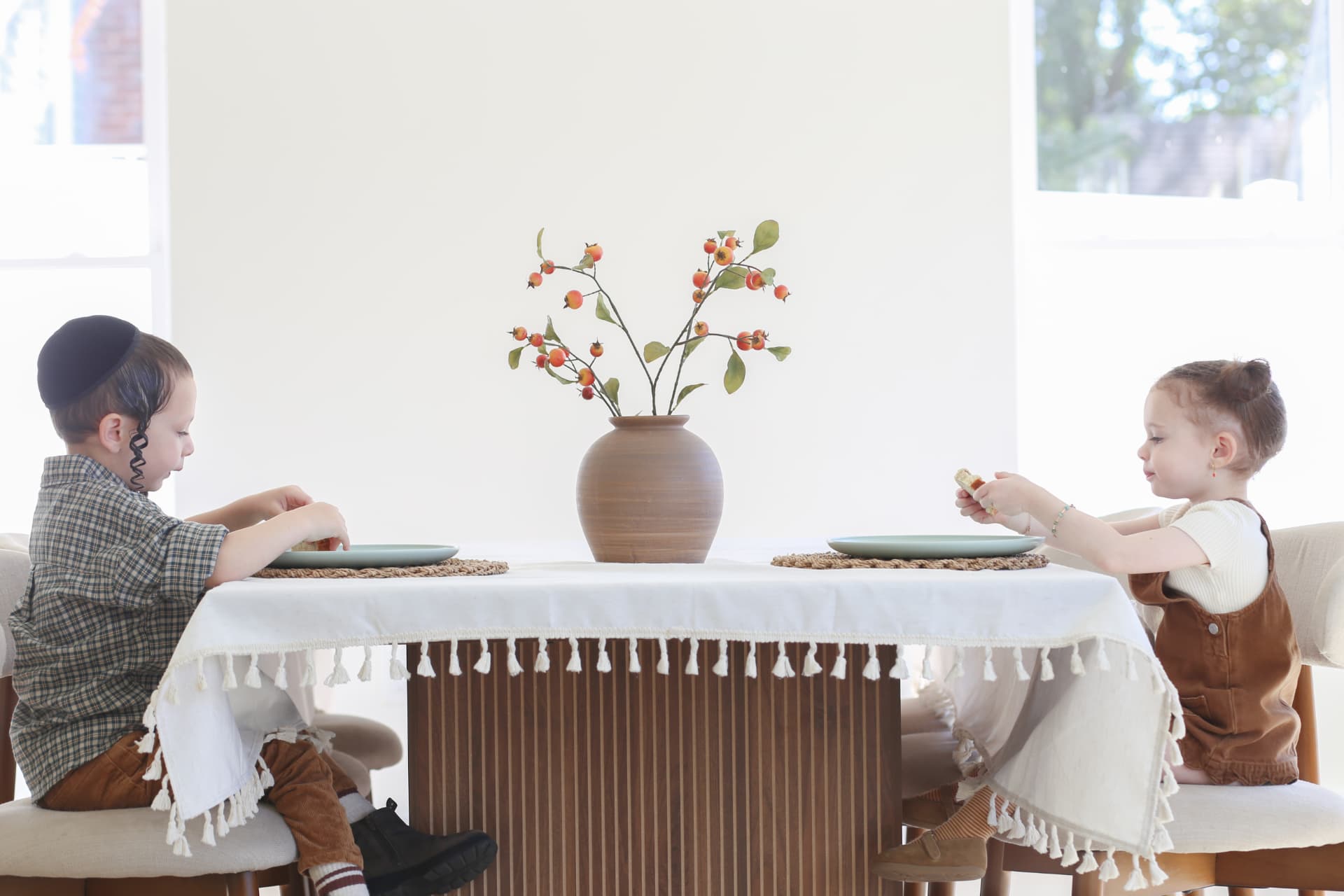Brother and sister across the dining table.
