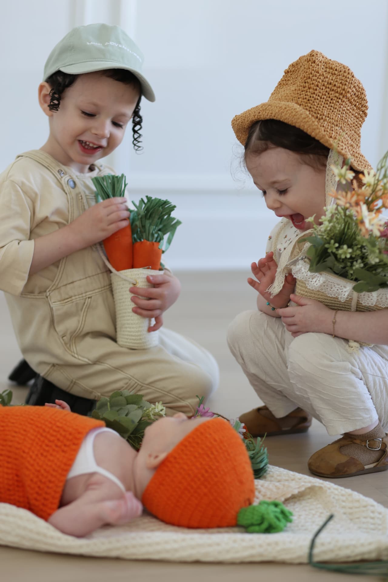 Big kids, baby, and a basket of carrots.