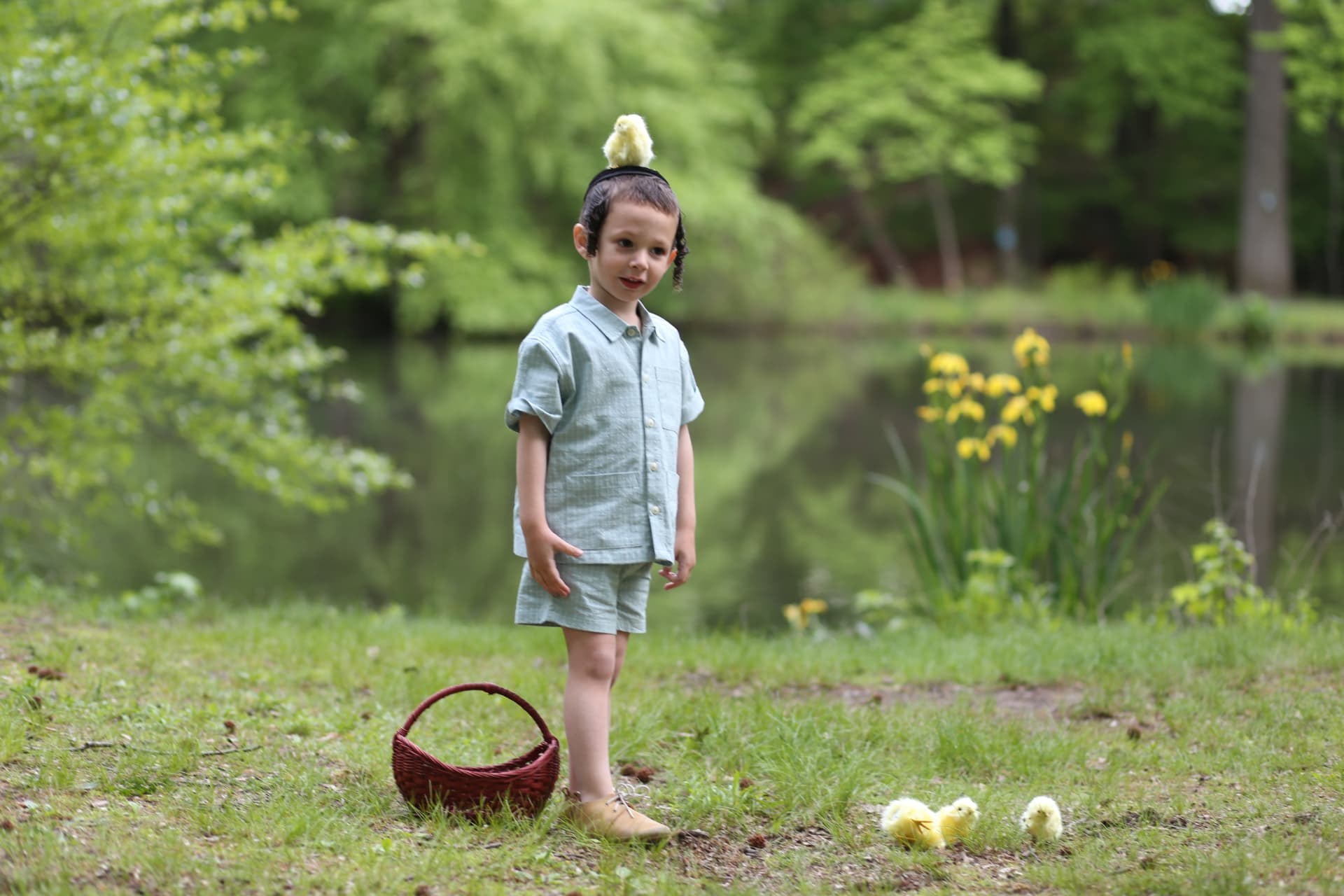 Standing barefoot in the grass by the pond.