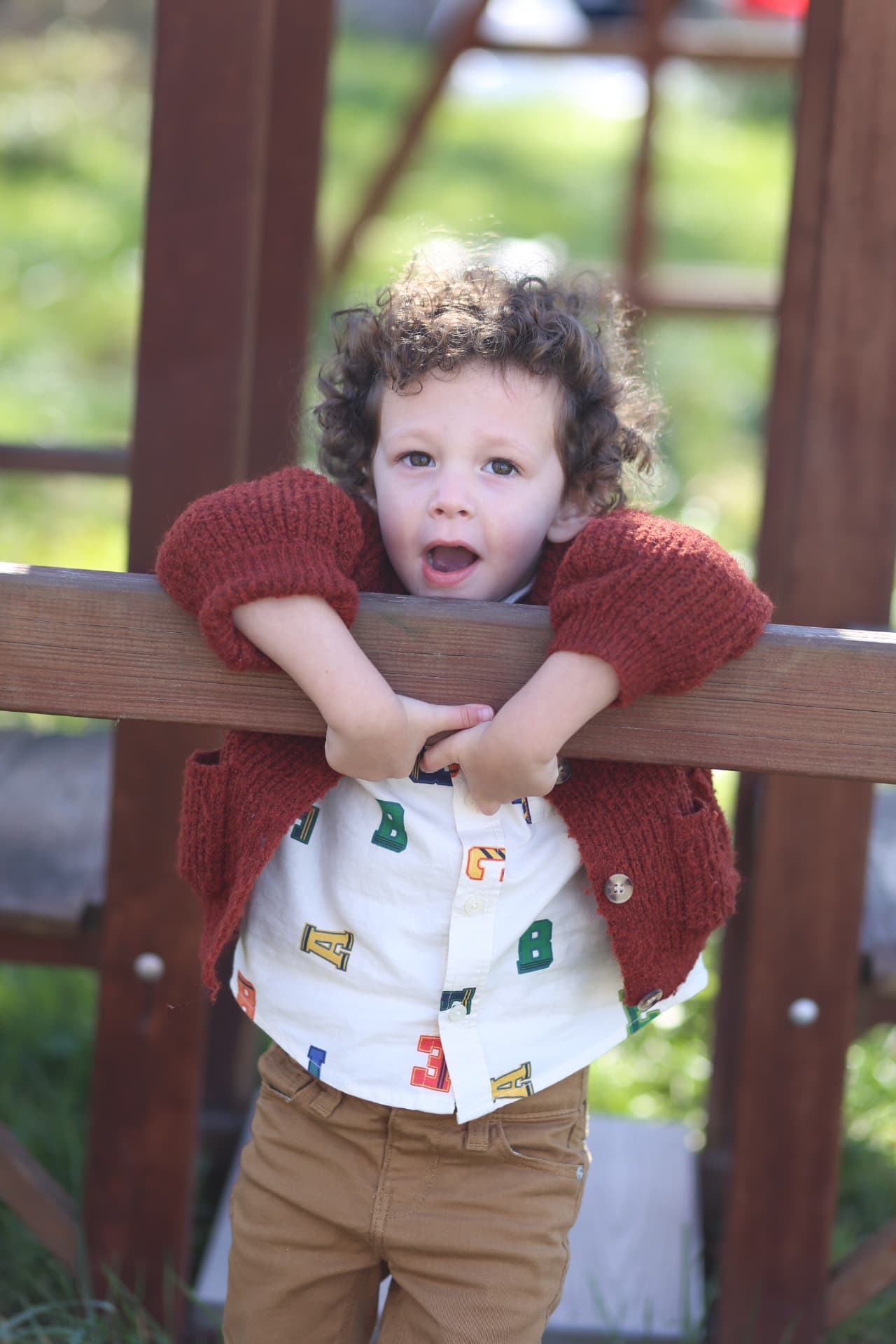 Chin over the rail, curls everywhere.