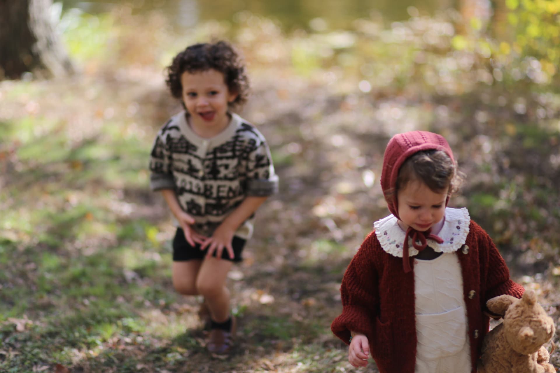Brother and sister crossing the leaves.
